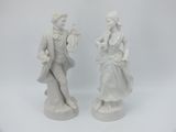 pair of white porcelain figurines of a man and a woman