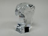 a clear glass elephant figurine sitting on a white surface
