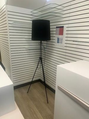 a television on a tripod in the corner of a room