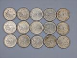 a close up of a bunch of silver coins on a table