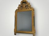 an image of a gold framed mirror on a white wall