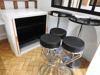four stools sitting in front of a counter in a kitchen