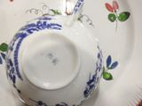 a blue and white plate with a blue and white tea pot on it