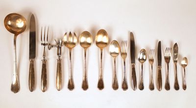 a lot of silver spoons and silverware on the table