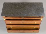 an image of a small wooden chest of drawers with a slate top