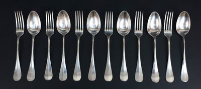 a set of six forks and spoons on a black background