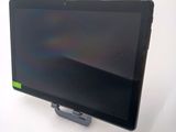 a tablet computer sitting on a stand on a white surface