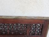 a wooden panel with beads on it on the floor