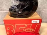 a helmet and a bag on a table next to a brick wall
