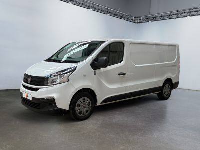 the white van is parked in the large room of the building
