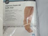 packaging of a bath mat with a pair of feet on it