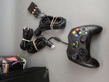 a video game controller sitting on a table next to a book