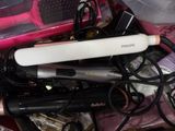 a hair dryer and a hair brush in a pile