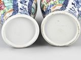 pair of blue and white vases with floral designs on them