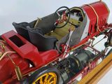 a model of a red and black car on a wooden stand