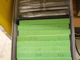 a person holding a box with a lot of green notes in it