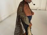 a figurine of a man with a pipe in his mouth
