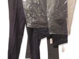 three pairs of pants hanging on a clothes rack