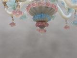 a glass chandelier hanging from a ceiling in a room