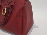 burgundy leather handbag with gold hardware on the handle