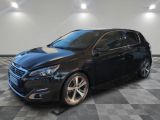 a black car is parked in a room with a checkered floor