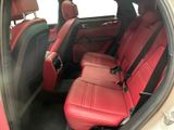 the interior of a car with red leather seats and black trims