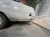 a white car that is parked on the side of the street