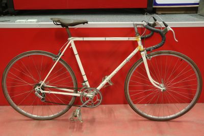 a bike that is parked in front of a red wall