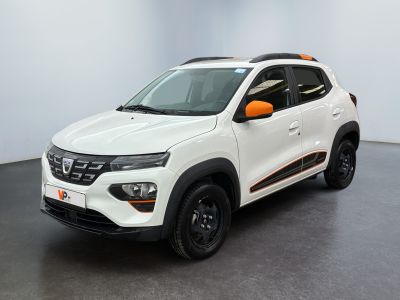 the white and orange car is parked in a large room