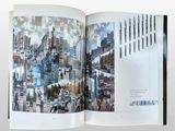 an open book with a picture of a city in it