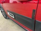 a close up of a car door handle with a sticker on it