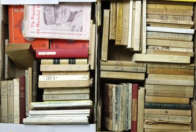 many books stacked on top of each other in a box