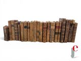 a lot of old books stacked on top of each other
