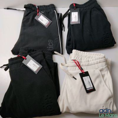 three pairs of black and white sweat pants with tags on them