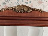 a mirror with a lion head on it in a room