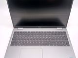 an open laptop computer sitting on top of a white table