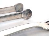 a fork, spoon, and spoon rest on a table