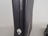 a video game console next to a charger on a table