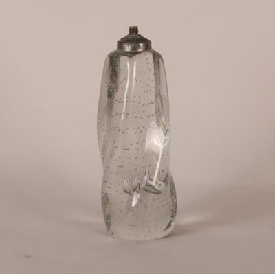 a clear glass bottle with a silver lid on a white surface