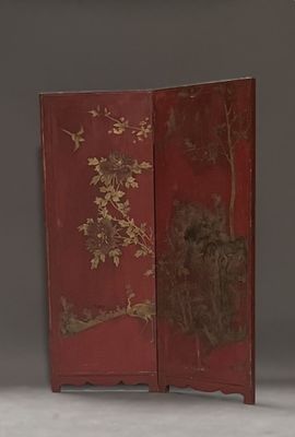 a red room divider with a bird and tree design on it