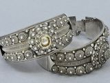 two silver bracelets with pearls and a pearl bead