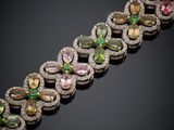 a bracelet with multi colored stones and diamonds on a black background
