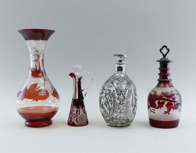 four different colored glass vases sitting next to each other on a white surface