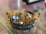 a bowl of food on a glass table with a keyboard in the background