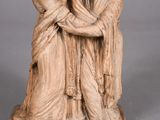 statue of a man and a woman embracing each other on a pedestal