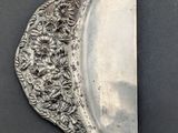 an image of a silver plate with a half moon on it
