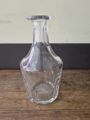 a clear glass vase sitting on a wooden table