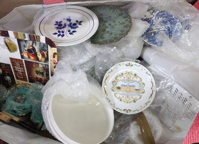 a box full of plates and bowls of food