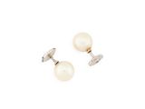 a pair of pearl earrings on a white background