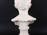 a white marble bust of a man on a pedestal